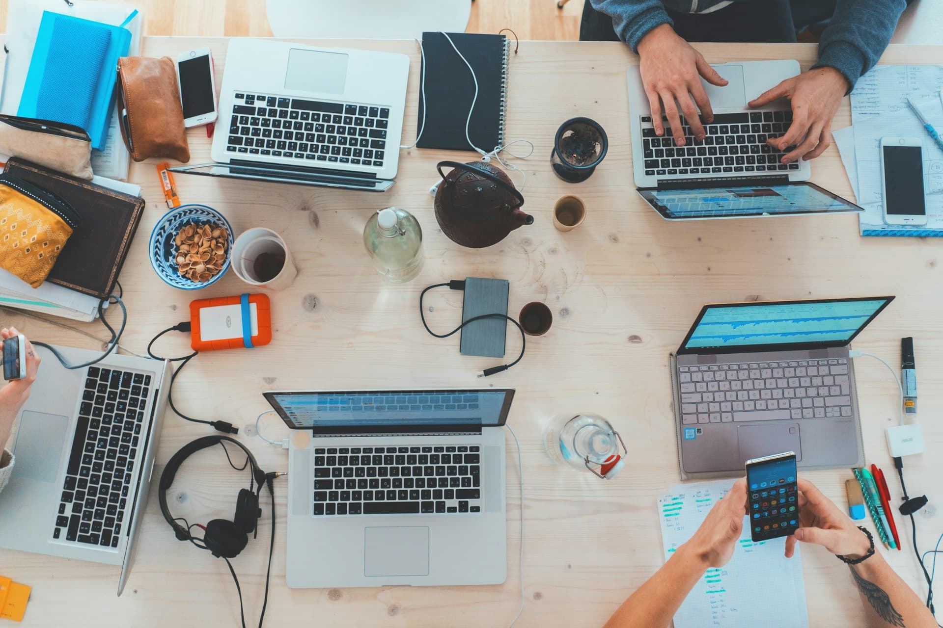 Team working together across laptops on one desk